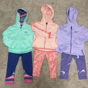 Two Nike size 2T and one under Armour outfit size 2T.